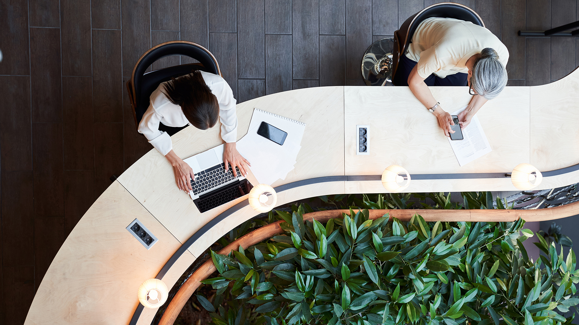 young student and adult woman working at the same desk